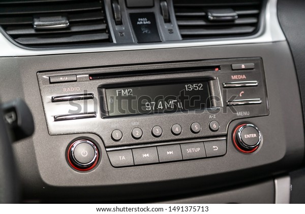 Novosibirsk, Russia – August 01, 2019:  Nissan Tiida,\
Modern black car interior: radio, audio system with monitor  and\
control buttons\
\
\
