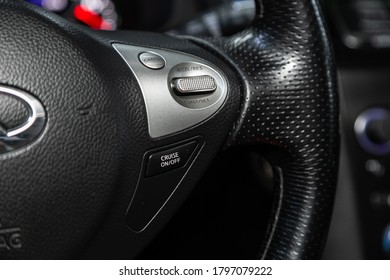 Novosibirsk/ Russia – August 01  2020: Infiniti FX, Car controller on steerling wheel ,Music,Control System Function and voice telephone in car. modern car interior