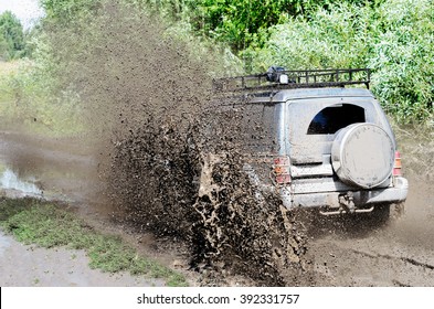 Novosibirsk, Russia - August 16, 2014: The Off-road Car Does The Splashing Mud, Driving Through A Puddle In Competitions Of Novosibirsk 16, August,  2014.