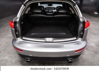 Novosibirsk, Russia – August 24, 2019:  Infiniti FX,  close-up of the open trunk, headlight, bumper,  front view. Exterior of a modern car 