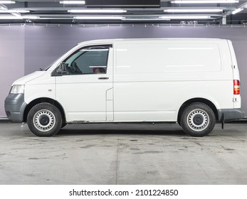 Novosibirsk, Russia - December 01, 2021: white Volkswagen Transporter ,  side view. Popular van on a parking   