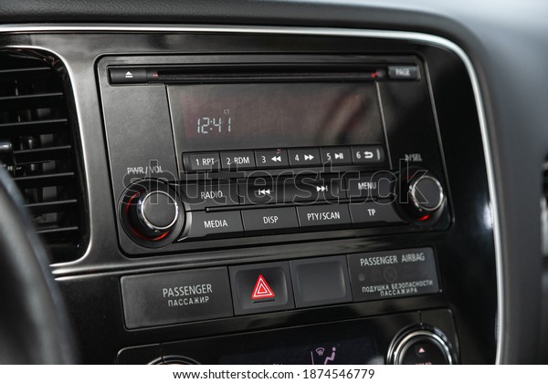 Novosibirsk, Russia – December 12, 2020:\
Mitsubishi Outlander,  black car interior: radio, tv, dvd, audio\
system with monitor  and control\
buttons