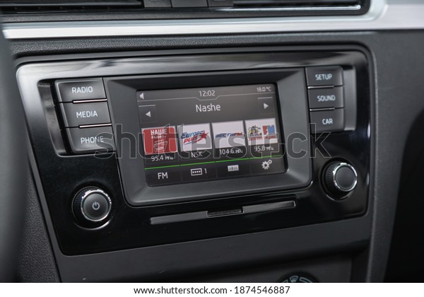 Novosibirsk, Russia – December 12, 2020: Skoda\
Rapid, black car interior: radio, tv, dvd,audio system with monitor\
 and control\
buttons