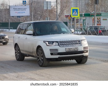 Novosibirsk, Russia - december 16 2020: private awd white metallic color british sport big crossover Land Rover Range Rover SWB luxury car SUV 4wd made in UK driving on snow urban frosty winter street