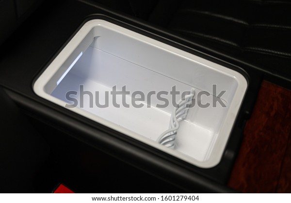 Novosibirsk,\
Russia – December 21, 2019:  Hyundai Equus, white new fridge with a\
compartment for bottles in the car\
panel