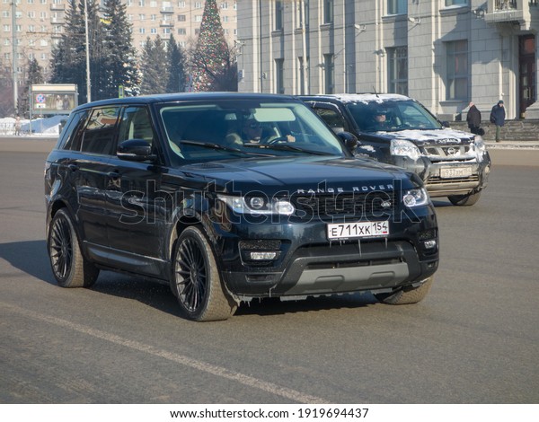 Novosibirsk, Russia - february 01 2020: private\
4wd awd all-wheel drive dark blue black metallic color  british\
frame crossover Land Rover Range Rover Sport L494 luxury SUV made\
in UK on winter\
street
