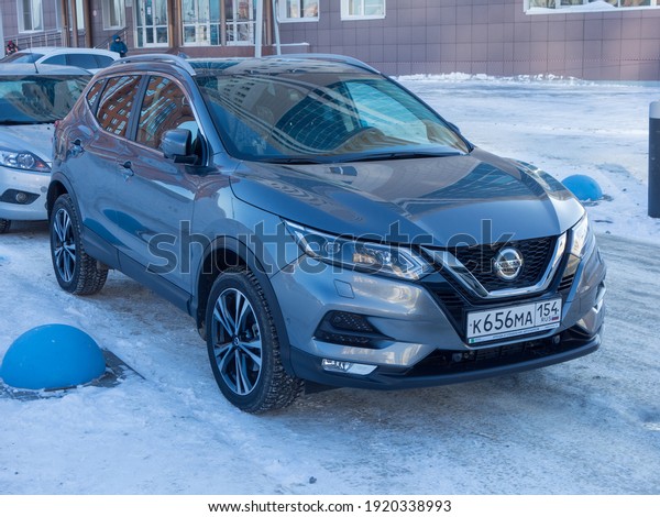 Novosibirsk, Russia - February 01 2021: private dark\
gray metallic color all-wheel drive japanese new small crossover\
Nissan Qashqai facelift, popular SUV car parking on winter urban\
street in yard