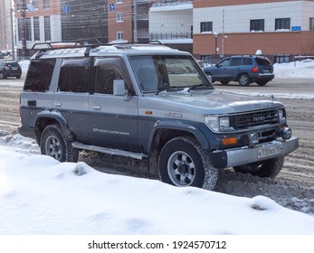 Novosibirsk, Russia - February 04 2021: Private Silver Gray Old Japanese All-wheel Drive 90s Car SUV Toyota Land Cruiser Prado 70 Station Wagon, Vintage Frame Jeep From Japan On The Winter Street