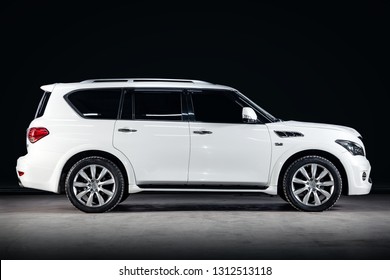 Novosibirsk, Russia - February 10, 2019:  Infinity QX56, Side View. Photography Of A Modern Car  On A Parking In Novosibirsk Against A Black Wall