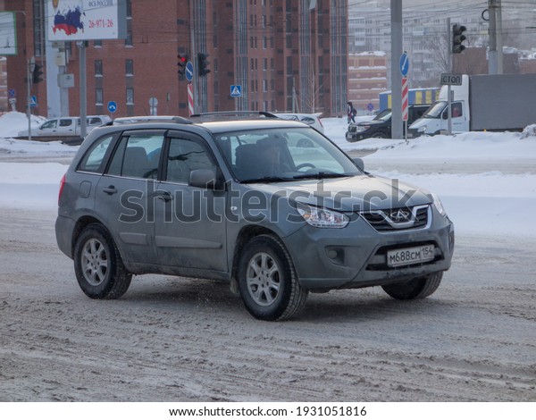Novosibirsk, Russia - February 10 2021: private\
all-wheel drive green gray metallic chinese small SUV crossover\
Chery Tiggo T11, popular car from China going in winter street\
Toyota RAV4 clone