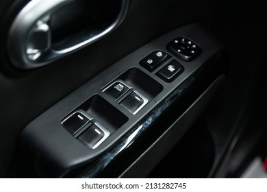 Novosibirsk, Russia -  February  10, 2022: Kia Soul, Car door interior armrest with window control panel, door lock button.