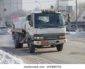 Novosibirsk, Russia - February 11 2020: White Color Japanese Fuel Tanker Truck Car Chassis MMC Mitsubishi Duso Fighter, Popular Small Cargo Mini Old Truck From 90s 2000s Going On The Winter Street 