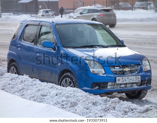 Novosibirsk, Russia - February 11 2021: private\
blue metallic color japanese small hatchback crossover SUV\
Chevrolet Cruze, rare all-wheel car, export import from Japan,\
parking in snow winter\
street