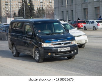 Novosibirsk, Russia - February 25 2021: Private Black Metallic Color Passenger Japanese Minivan Old Car Honda Stepwgn 90s, Station Wagon Van Mini Bus Export Import From Japan Driving On Snow Street