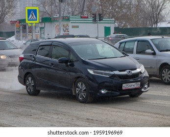 Novosibirsk, Russia - February 26 2021: Private Dark Blue Metallic Color Passenger Japanese Minivan New Car Honda Shuttle (Fit), Station Wagon Van Mpv Export Import From Japan Driving On Snow Street