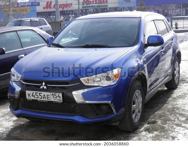 Novosibirsk, Russia - February 28 2018: private\
awd dark blue metallic all-wheel drive japanese small crossover\
basic cheap Mitsubishi ASX facelift (RVR), popular SUV car made in\
Japan on urban\
street