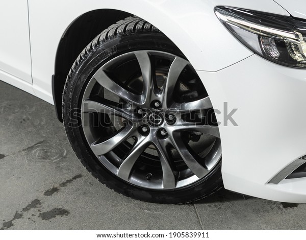 Novosibirsk, Russia – January 14 2021: Mazda 6,\
Car wheel with alloy wheel and new rubber on a car closeup. Wheel\
tuning disc\
