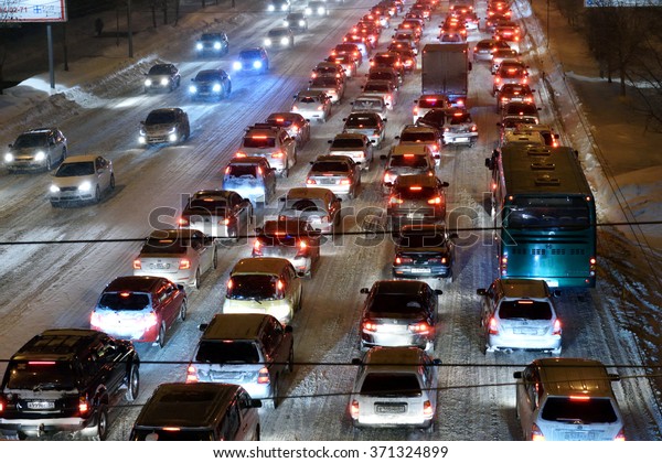 NOVOSIBIRSK, RUSSIA - JANUARY 21, 2015: Car traffic\
in the city center in a winter evening. The city reached the\
milestone of 1 million inhabitants in 70 years, and is one of the\
first in the world