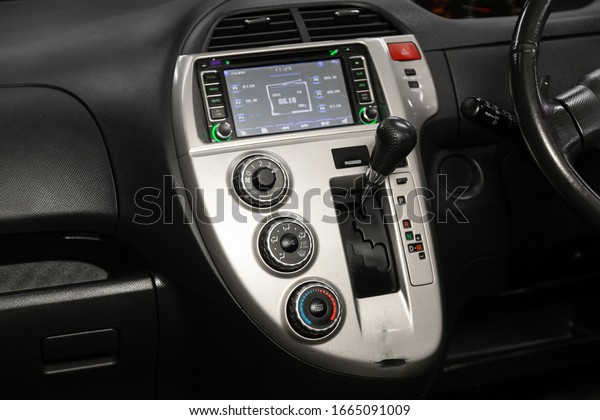 Novosibirsk, Russia –  January 24, 2020:\
Toyota Ractis, close-up of the central control panel, monitor with\
music and radio , adjustment of the blower, air conditioner,\
player. modern car\
interior\
