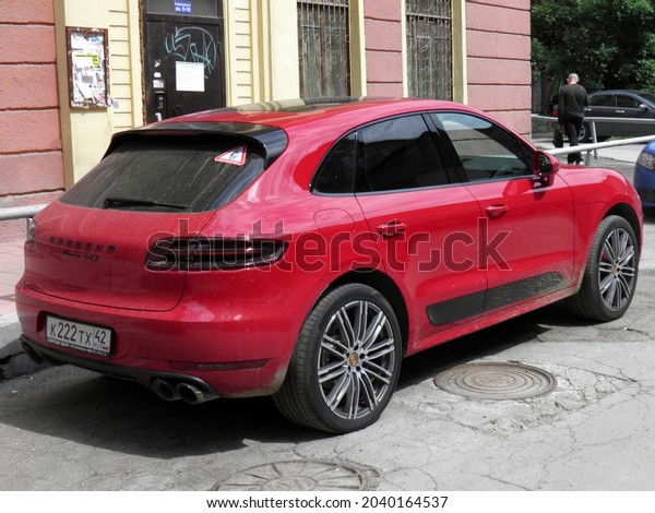 Novosibirsk, Russia - july 07 2017: private\
all-wheel drive red metallic color compact sport fast coupe\
crossover Porsche Macan GTS 95B, made in Germany luxury awd 4wd SUV\
car on urban city\
street