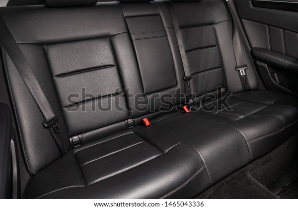 Novosibirsk, Russia – July 09, 2019: Mercedes\
Benz E-Class, close-up of the black leather  rear seats with seats\
belt. modern car\
interior\
