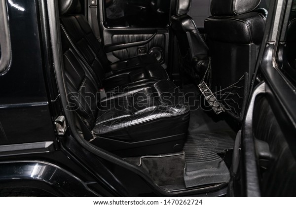Novosibirsk, Russia – July 12, 2019:   black\
Mercedes-Benz G-class, close-up of the black  leather rear seats\
with seats belt. modern car\
interior\
