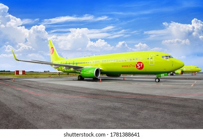 NOVOSIBIRSK, RUSSIA - July 14, 2020: Tolmachevo Airport, airplane Boeing 737-800 on airfield blue sky background close up, s7 Airlines aircompany, passenger airliner, green jet plane stands on runway