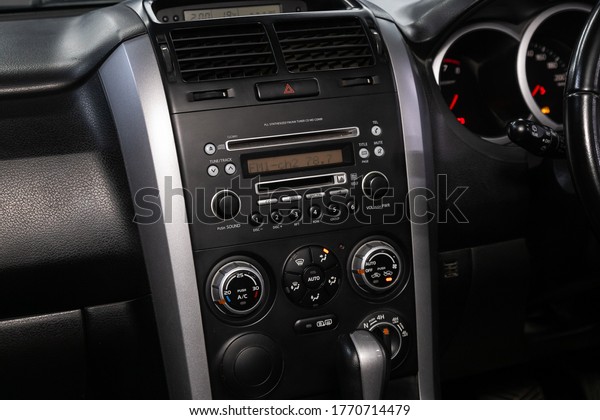 Novosibirsk/ Russia – June  03 2020:Suzuki\
Escudo, close-up of the central control panel, monitor with music\
and radio , adjustment of the blower, air conditioner, player.\
modern car\
interior\
