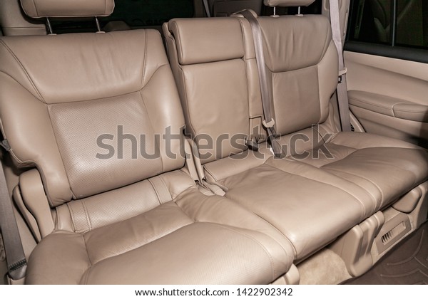Novosibirsk, Russia – June 11, 2019:  Lexus\
LX570, close-up of the beige leather  rear seats with seats belt.\
modern car\
interior\
\

