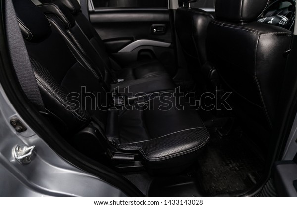 Novosibirsk, Russia – June 18, 2019:\
Mitsubishi Outlander,close-up of the black leather  rear seats with\
seats belt. modern car\
interior\
