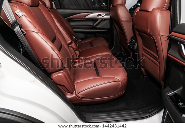 Novosibirsk, Russia – June 28, 2019:  Mazda\
CX-9, close-up of the brown leather  rear seats with seats belt.\
modern car\
interior\
