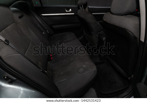 Novosibirsk, Russia – June 28, 2019:\
Mitsubishi Galant,close-up of the black  rear seats with seats\
belt. modern car\
interior\
