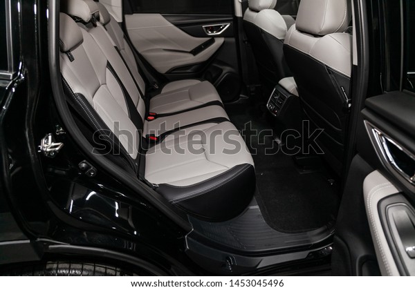 Novosibirsk, Russia – June 30, 2019:  Subaru\
Forester, close-up of the black  and white leather rear seats with\
seats belt. modern car\
interior\
