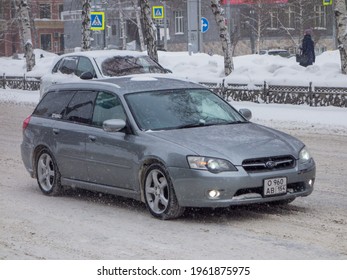 Novosibirsk, Russia - March 01 2021: Private Awd All Wheel Drive Dark Silver Gray Metallic Color Japanese Station Wagon Car Subaru Legacy, Export Import From Japan Driving On Snow Winter Street 