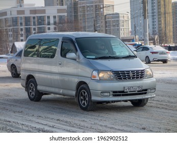 Novosibirsk, Russia - March 02 2020: Private Silver Gray Metallic Color Passenger Japanese Minivan Car Toyota Grand Hiace, Station Wagon Van Mini Bus Export From Japan Driving On Snow Winter Street