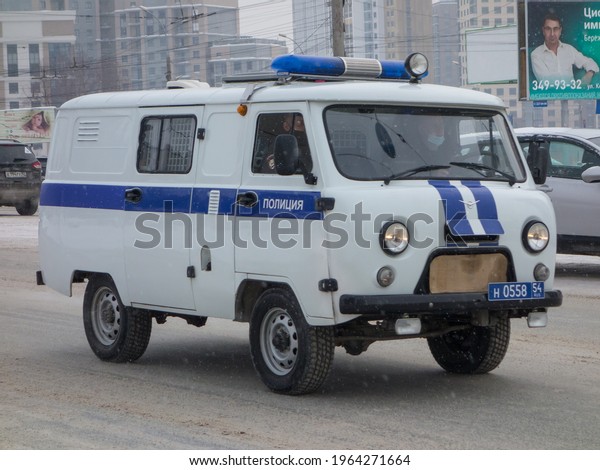 Novosibirsk, Russia - march 03 2020: private white\
blue color russian all-wheel drive old USSR police car - UAZ 3909\
(452), classic soviet union jeep started production from 50s\
driving on the\
street