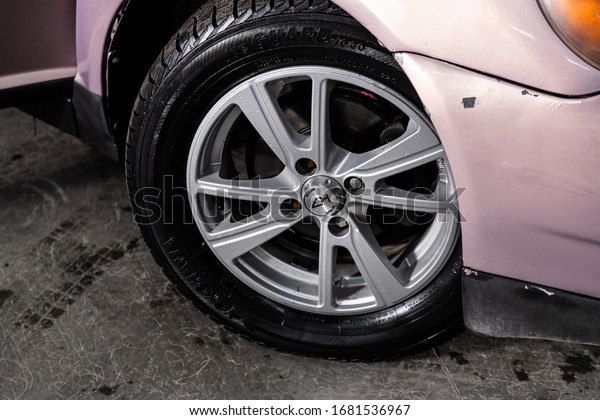  Novosibirsk, Russia – March  04, 2020:  Toyota\
Platz, Car wheel with alloy wheel and new rubber on a car closeup.\
Wheel tuning disc\
\
