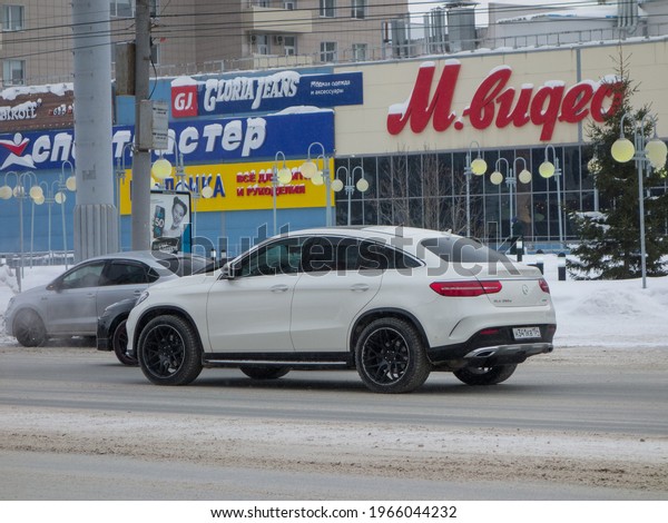 Novosibirsk, Russia - march 04 2021: private awd\
all-wheel drive white color germany SUV Mercedes-Benz GLE 350d\
4МАТIС C292, new luxury car coupe crossover from Germany driving on\
winter snow street