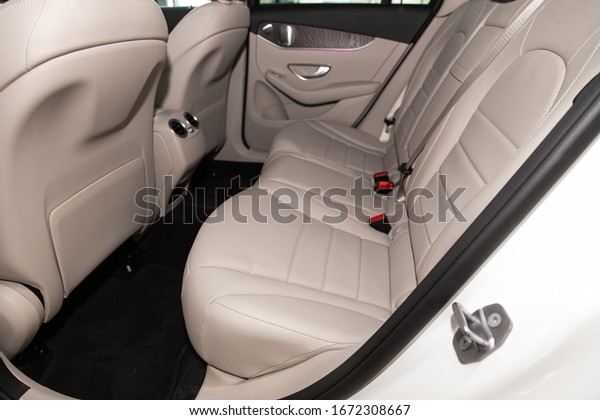 Novosibirsk, Russia – March 07, 2020: \
Mercedes-Benz GLC-class, close-up of the white leather  rear seats\
with seats belt. modern car\
interior\
\
