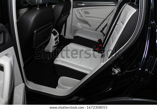 Novosibirsk, Russia – March 09, 2020: \
Volkswagen Tiguan,close-up of the black and white leather  rear\
seats with seats belt. modern car\
interior\
\
