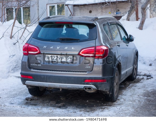 Novosibirsk, Russia - March 11 2021: private awd\
all-wheel drive brown metallic color chinese family midsize SUV\
Great Wall Haval H6, new car crossover made in China parking on\
snow winter street