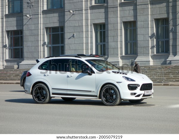 Novosibirsk, Russia - march 17 2021: private awd\
all-wheel drive 4wd 4x4 white metallic color germany tuned sport\
coupe crossover TechArt Porsche Cayenne (958) luxury car SUV\
driving on urban\
street