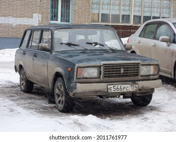 Novosibirsk, Russia - March 24 2021: Blue Metallic Color Russian Rwd Drive Old Classic Vintage Station Wagon VAZ Lada 2104 Zhiguli, Made In Soviet Union Parking On Snow Winter Urban Unpaved Street