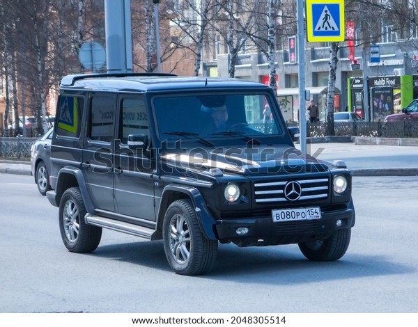 Novosibirsk, Russia - May 04 2021: private big awd\
all-wheel drive black metallic color germany SUV Mercedes-Benz G500\
4МАТIС W463 old luxury classic brutal car crossover parking on\
urban city street