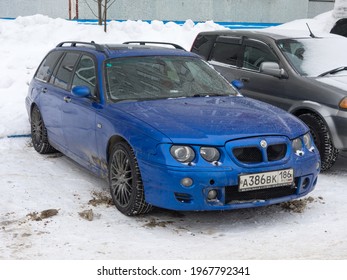 Novosibirsk, Russia - May 05 2021: Private All-wheel Drive Dark Deep Blue Metallic British Sport Station Wagon MG ZT-T Based On Rover 75, Old Car From 90s 2000s From UK Parking On Snow Winter Street