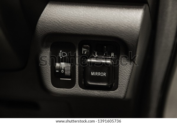 Novosibirsk, Russia - May 06, 2019:  Honda\
Fit Aria,close-up of the headlight adjustment buttons. Photography\
of a modern car on a parking in\
Novosibirsk\
