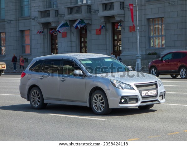 Novosibirsk, Russia, may 07 2021: private awd\
silver gray metallic color family japanese station wagon old car\
2000s Subaru Legacy BR B14 with Audi Q7 bumper, export import drive\
on city urban\
street