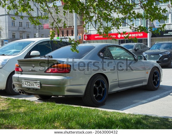 Novosibirsk, Russia, may 11 2021: private silver\
gray metallic old japanese rwd rear wheel drive car Nissan Silvia\
S15 Spec S with Enkei wheel rims, old classic sport coupe 90s 2000s\
parking on street