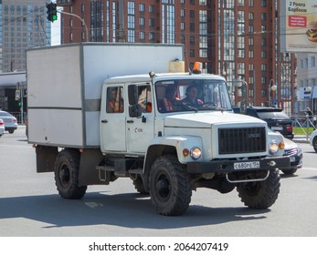 Novosibirsk, Russia - May 12 2021: White Small Dual Cab Box Military Truck Chassis Car Awd 4x4 GAZ 3308 Eger Diesel Old Classic Made In Russia, Mobile Workshop SGK Company Owned With Elderly Driver