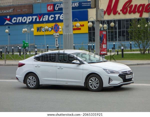Novosibirsk, Russia, may 13 2021: private fwd\
compact white metallic color new cheap economy sedan South Korean\
car Hyundai Elantra 2016 facelift 2018, popular bestseller drive on\
city urban street